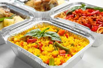 Lunchboxes on white wooden table, closeup. Healthy food delivery