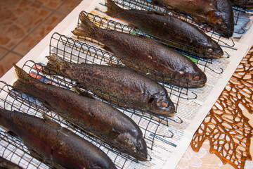 Fresh smoked fish in a smokehouse: carps, trouts