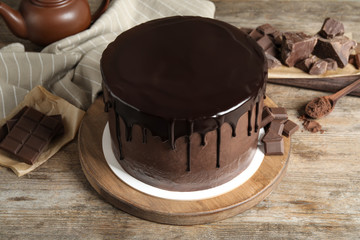 Freshly made delicious chocolate cake on wooden table