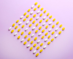 Colorful jelly beans on lilac background, flat lay