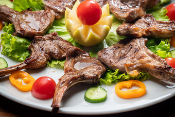 Juicy baked ribs with pork and veal meat. With vegetables.