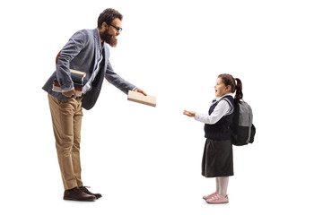 Man giving a book to a little schoolgirl