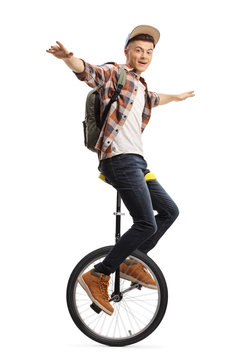 Excited male student riding a unicycle
