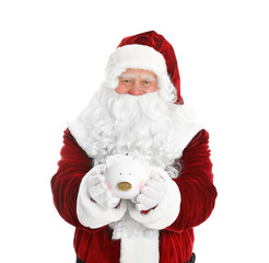 Santa Claus holding piggy bank on white background