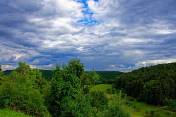 Fototapeta na wymiar Beautiful sky with clouds near the forest