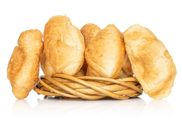Group of five whole fresh baked mini croissant in wicker vine circle isolated on white background