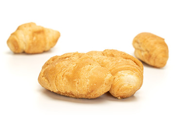 Group of three whole fresh baked mini croissant isolated on white background