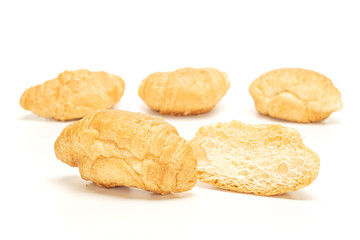 Group of three whole two halves of fresh baked mini croissant isolated on white background