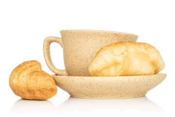 Group of two whole fresh baked mini croissant with cup and saucer isolated on white background