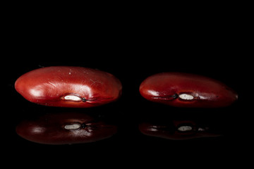Group of two whole fresh red kidney beans isolated on black glass