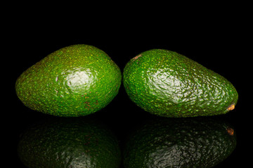 Group of two whole fresh green avocado isolated on black glass
