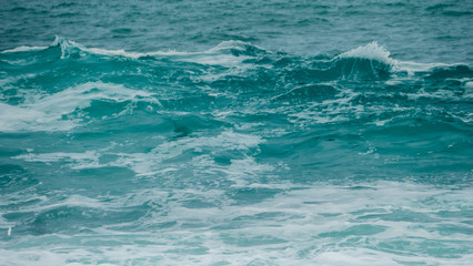 Sea surf blue waves and white foam