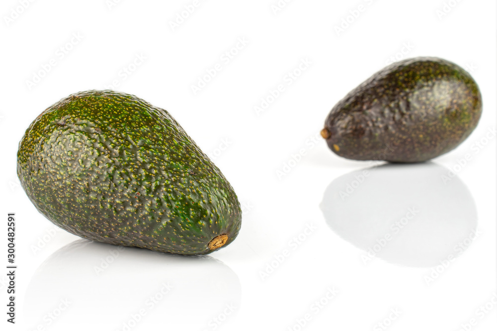 Wall mural Group of two whole fresh green avocado isolated on white background