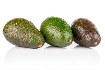 Group of three whole fresh green avocado isolated on white background