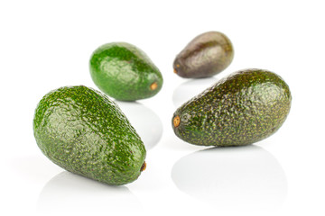 Group of four whole fresh green avocado isolated on white background