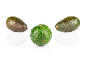 Group of three whole fresh green avocado isolated on white background