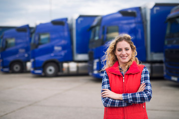 Truck driver occupation. Portrait of woman truck driver in casual clothes standing in front of...