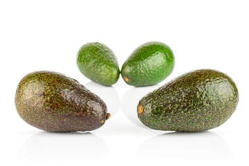 Group of four whole fresh green avocado isolated on white background