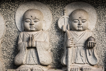 Small Buddhist sculptures carved on a temple wall
