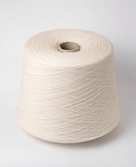 bobbin of yarn on a white background. Side view.Textile reel on isolated white background.