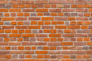 Bright textured red brick wall