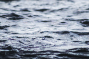 Beautiful   blue sea water surface with low waves. Seascape background. Calm Dark Sea Waves. Close-up, shallow focus.