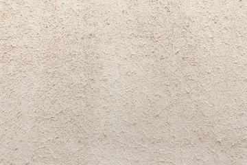 Fototapeta premium Textured light cement wall with spatula