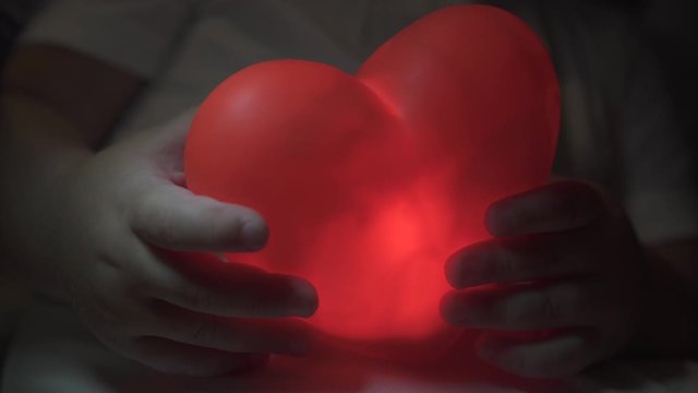 heart in the hands of a child closeup