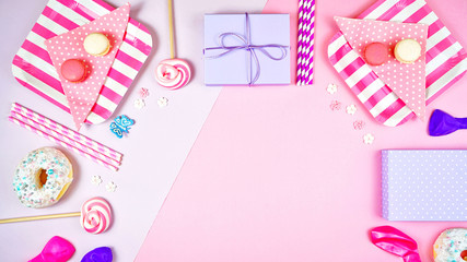 Colorful pink theme birthday party flat lay with snack, balloons, lollipops and gifts with negative copy space.