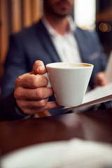 Man holding cup of coffee,close up view