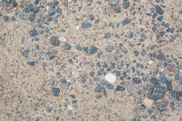 stretch of road closeup of land, sand and granite stones