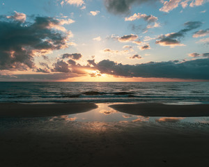 Naklejka na ściany i meble sunrise reflections on beach