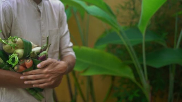 Eco-friendly product packaging concept. Vegetables wrapped in a banana leaf, as an alternative to a plastic bag. Zero waste concept. Alternative packaging