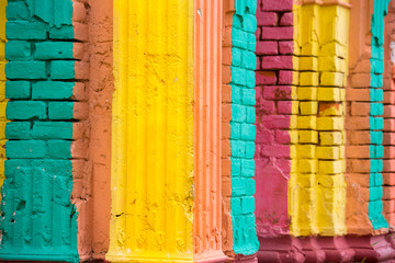 Red, Orange, yellow and blue color combination old Textured damage wall with Colorful Bricks.