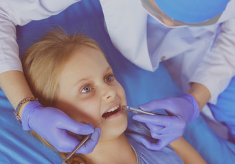 Little girl sitting in the dentists office.