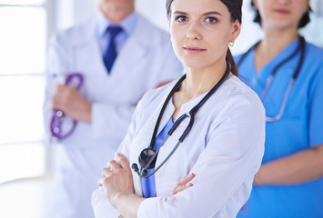 Fototapeta premium Group of doctors and nurses standing in a hospital room