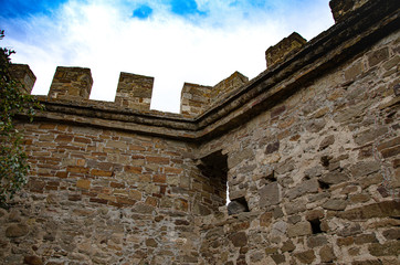 The old fortress. Wall, watchtower of an old fortress in the mountains. Middle Ages. Archeology.