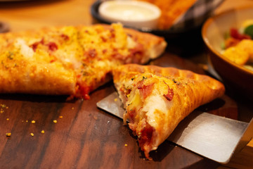 pizza puff on wooden plate