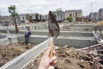 Old trowel is a tool for plastering on construction sites.