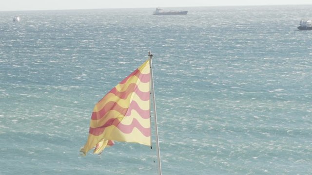 Tarragona Flag in Slow motion Over Ocean