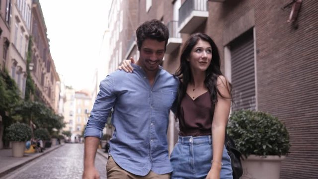 Cute hugging couple walking around and having fun