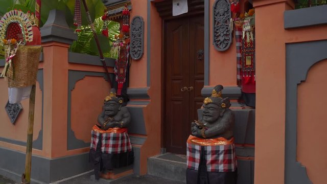 Steadicam shot of decorations made on an entrance to balinese house to celebrate Galungan holidays. The cultural life of Bali concept