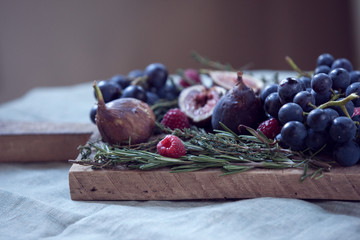 Corner and eye level view of a fruit tray on a wooden chopping board