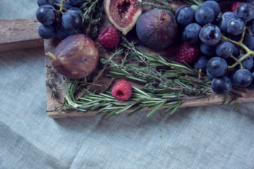 Corner of a wooden cutting board loaded with fresh organic home grown garden foods