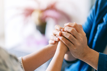 A man holding a woman's hands to show love and care