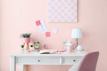 Modern stylish workplace near color wall