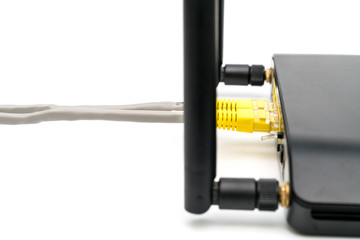 Black wireless router with local area network cable isolated on white background
