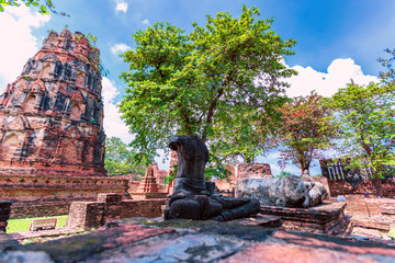 Headless Buddha sits in the center of crumbling structures at the ancient historic city of Ayutthaya