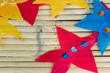 Fototapeta na wymiar Close up to traditional star-shaped kite or thai name Chula kite for sale to fly at local market. Selective focus.