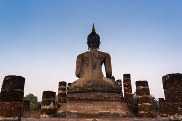 Buddha statue with ruined temple